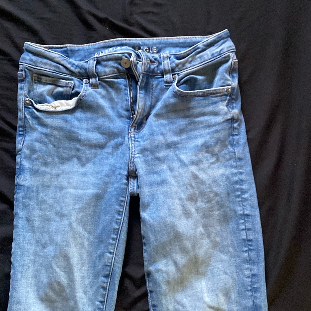 Medium wash, kick boot style front and back pockets button and zipper